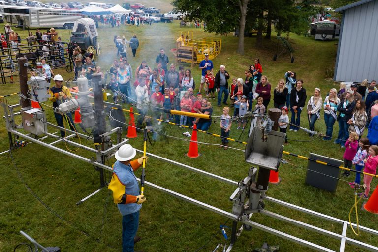 The South Central Indiana line crew gives a live-line demonstration during the Children's Farm Festival at Peden Farm.