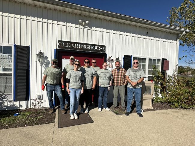 Jackson County REMC employees pose after a day of work at Scott County Clearinghouse, a food pantry in Scottsburg.