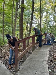 RushShelby Energy employees work on railings at Camp Woodsmoke during Community Day.