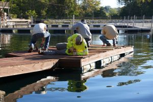 WIN Energy employees rebuild a dock at YMCA Camp Carson during Community Day.